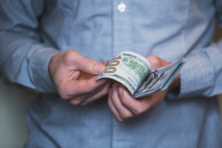 Businessman-holding-money-in-his-hands-PQRBNZW Businessman-holding-money-in-his-hands-PQRBNZW